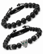 Black onyx beaded bracelet stack with braided tags and silver-tone lion charm