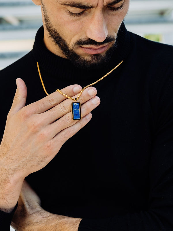 Gold lapis lazuli rectangle pendant necklace worn close-up by a model