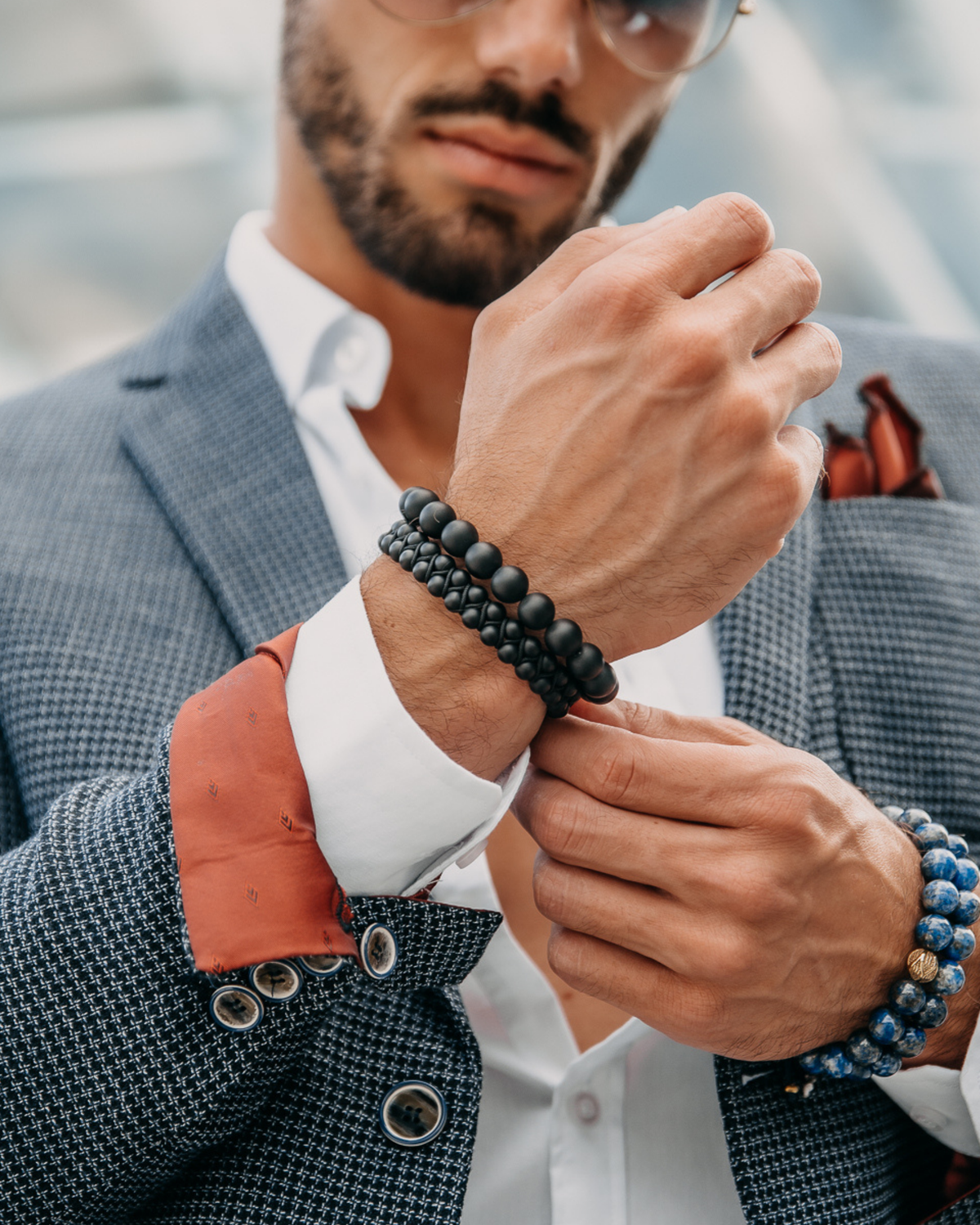 Black beaded bracelet with woven center detail on a man’s wrist