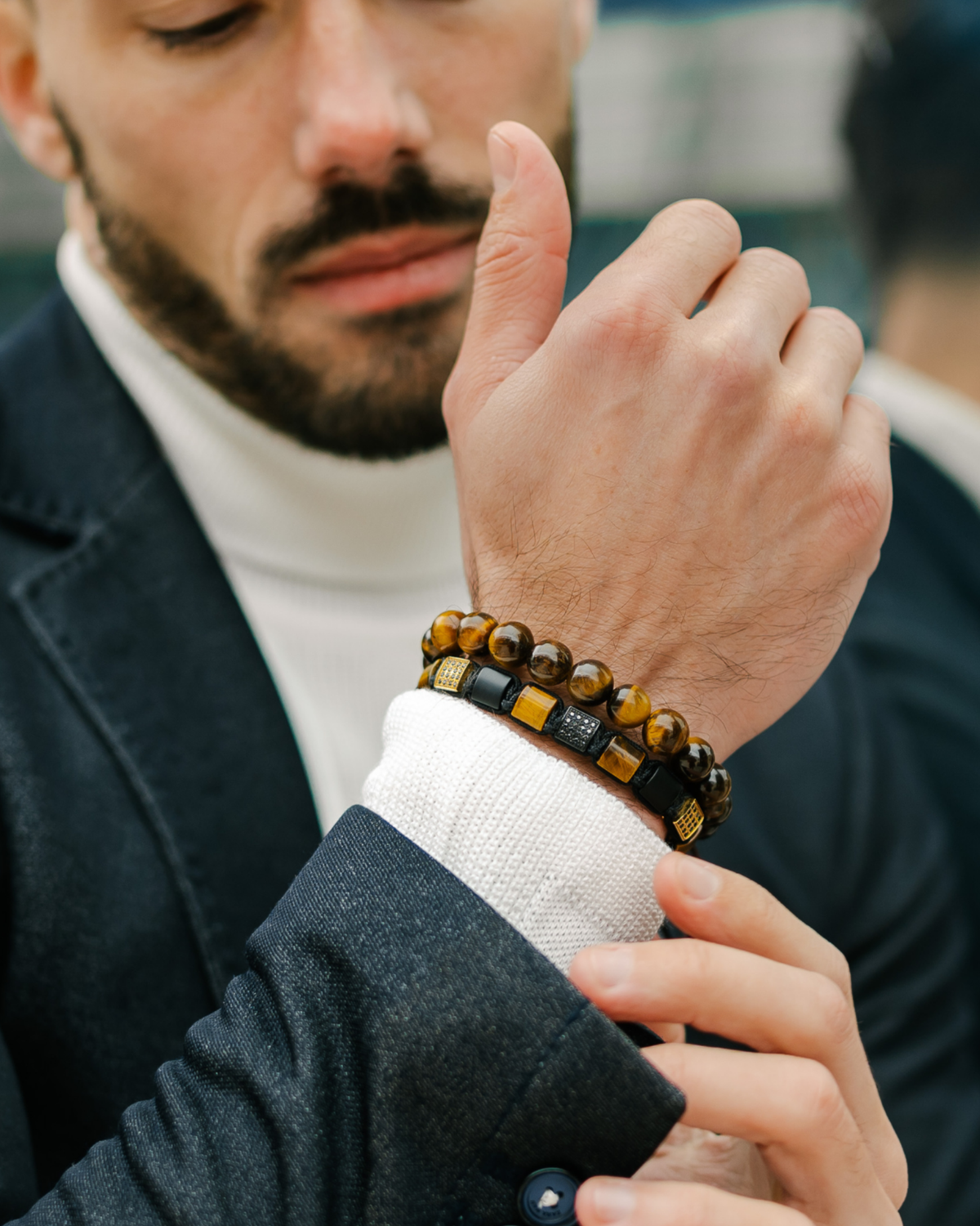 Tiger eye bracelets on wrist: dark cord band with tiger eye beads and beaded strand