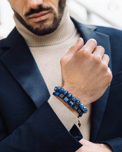 Lapis lazuli bead bracelet on a man’s wrist with navy blazer cuff