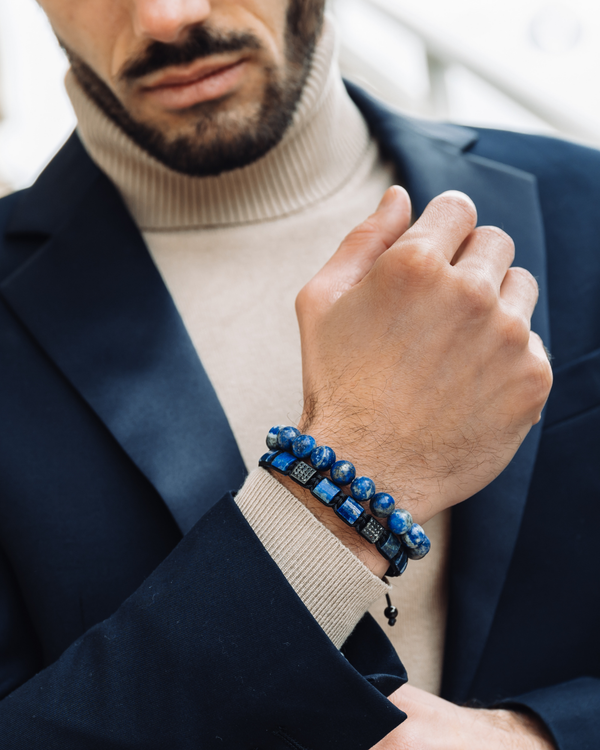 Lapis lazuli bead bracelet on a man’s wrist with navy blazer cuff