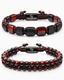 Two beaded bracelets with red/orange stones and black accents, flat lay