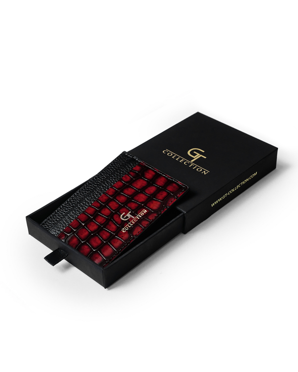 Red croc-embossed leather card holder in gift box with gold logo.