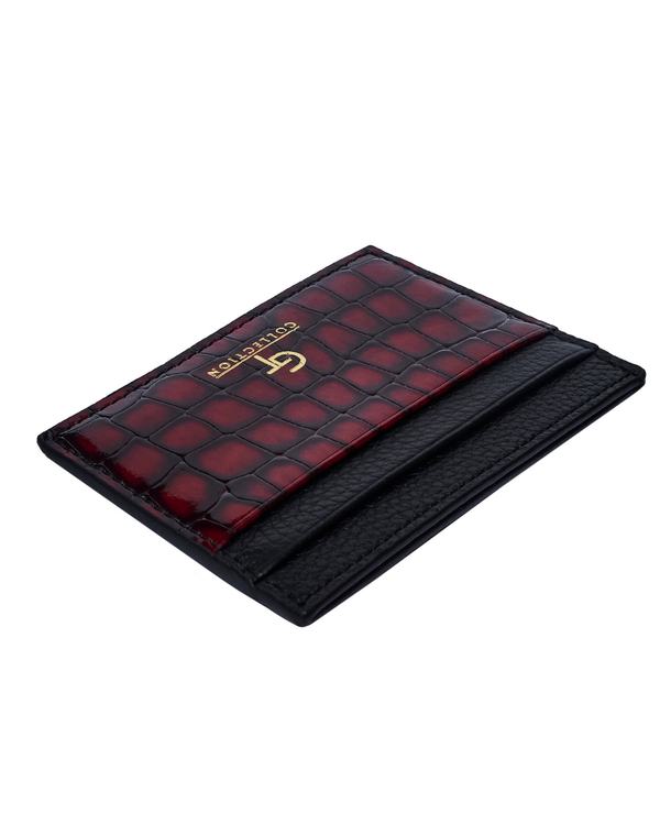 Slim red croc-embossed leather card holder with black edge, gold logo on top.