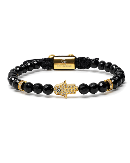 Black bead bracelet with gold Hamsa charm and gold accent beads, macrame center.