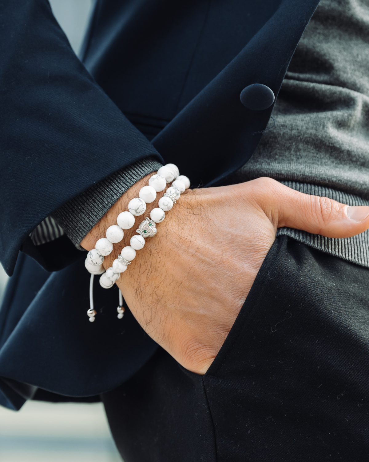 Howlite beaded bracelets on wrist, white beads with silver spacer accents