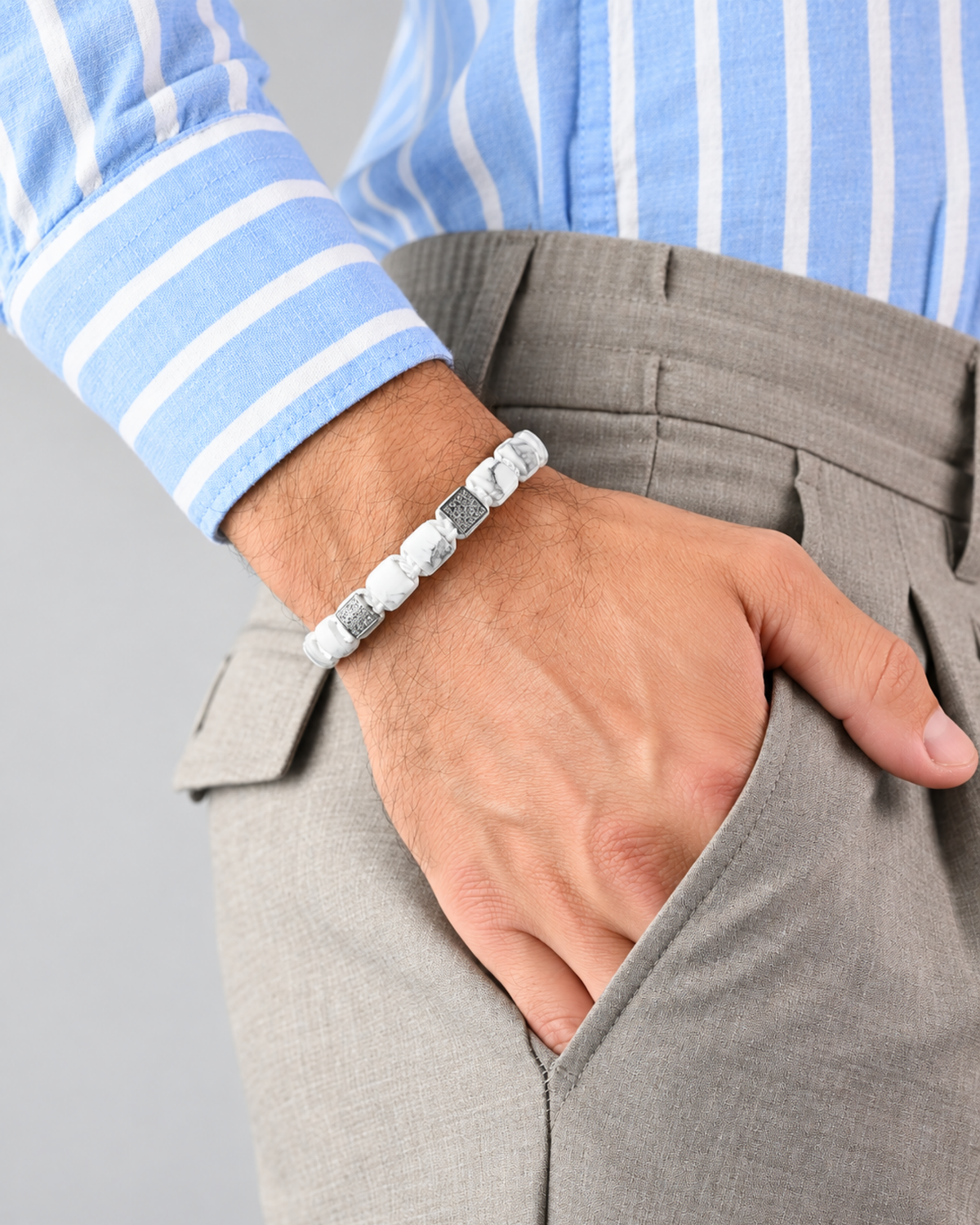 White marble-effect bead bracelet worn on wrist with silver clasp beads