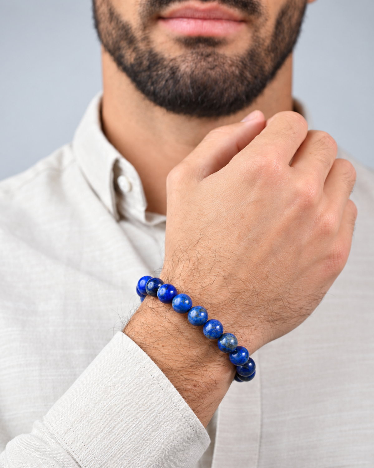 Lapis lazuli beaded bracelet worn on wrist with white button-up shirt
