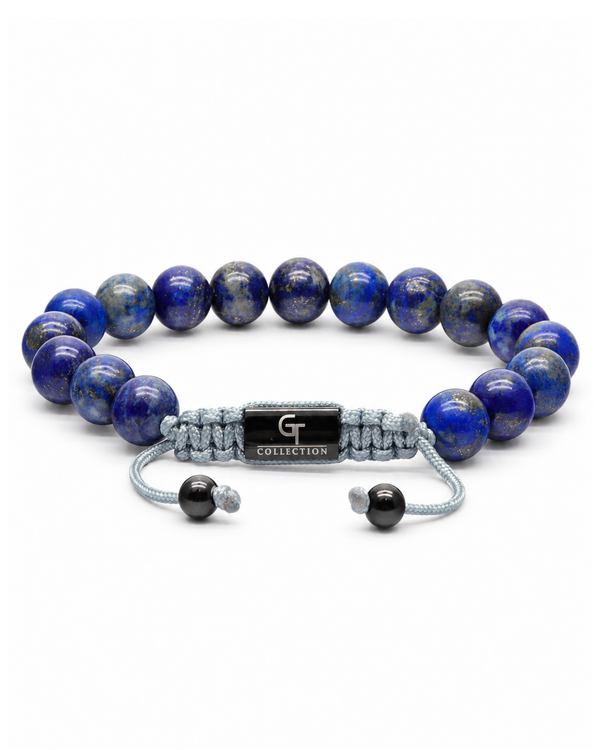 Blue lapis lazuli bead bracelet with gray cord and engraved metal centerpiece