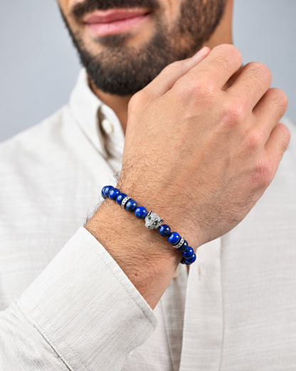 Lapis lazuli bead bracelet on man's wrist with animal-head charm