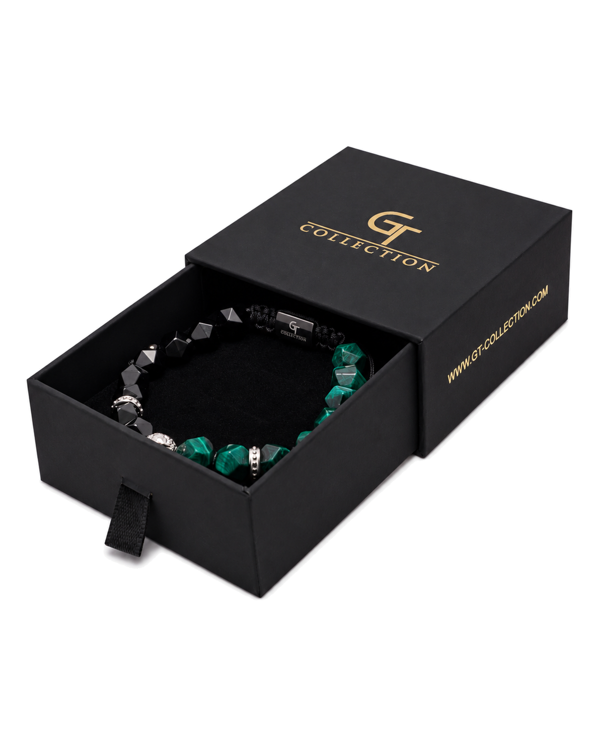 Lion charm bracelet resting in a black gift box with black and green faceted beads.
