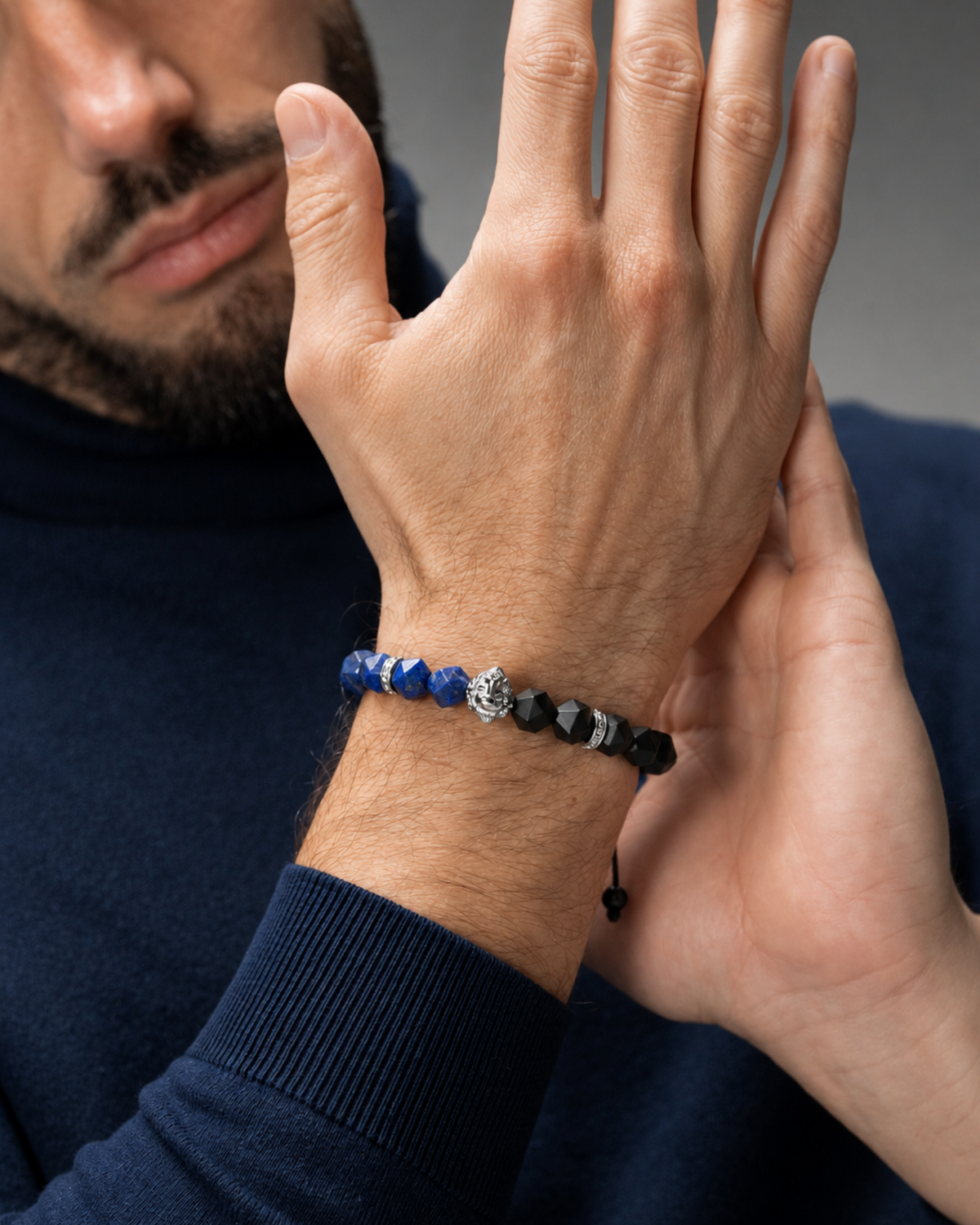 Man wearing lapis lazuli and black onyx beaded lion bracelet on wrist