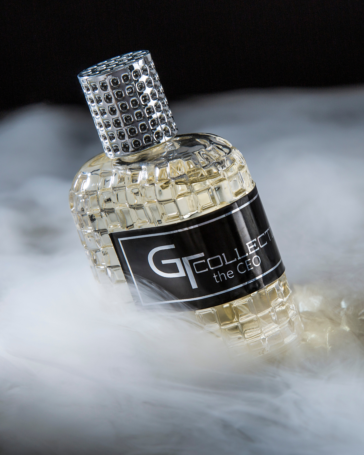 Men's eau de parfum bottle in clear gold glass with G Collection the CEO label