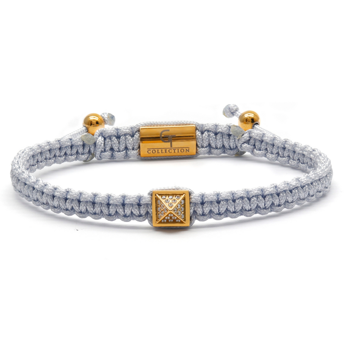 Men's pyramid bracelet with light gray braided cord and gold rectangular centerpiece with pyramid