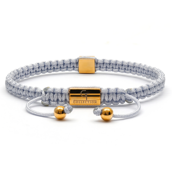 Men's pyramid bracelet with light gray cord, gold centerpiece, and gold bead accents