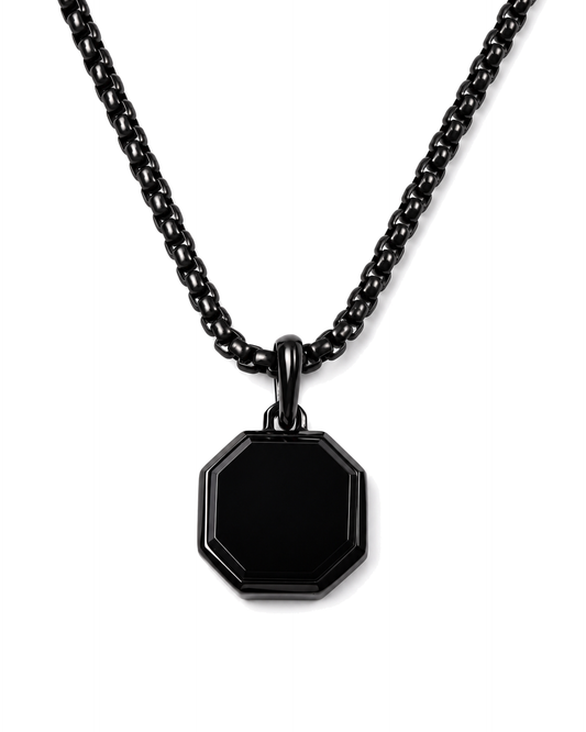 Black octagonal pendant necklace with curb chain on white background
