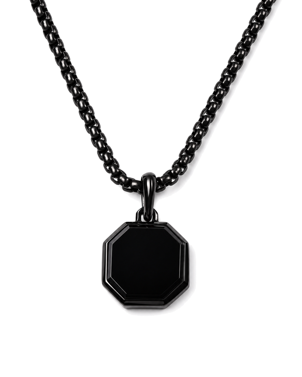Black octagonal pendant necklace with curb chain on white background