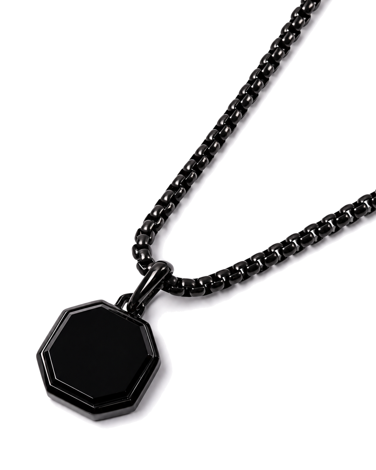 Black octagonal pendant on curb chain, angled close-up