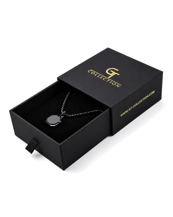 Black octagonal pendant necklace on chain, shown in gift box