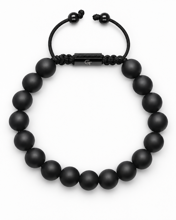 Black bead bracelet featuring woven center bar with small end beads