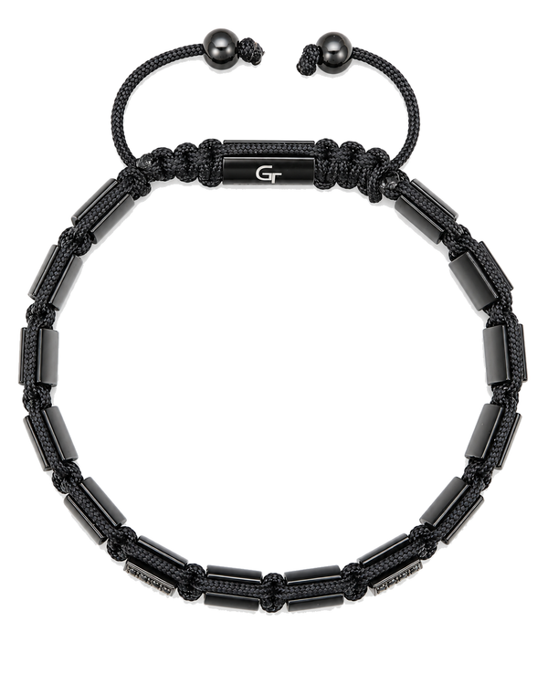Black beaded bracelet top view with braided cord, metal end beads, and central plate