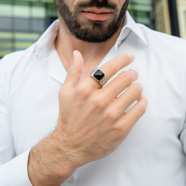 Silver onyx-stone ring on a man’s hand