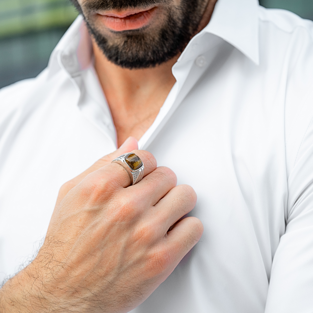Men's sterling silver ring with tiger eye stone on man's hand