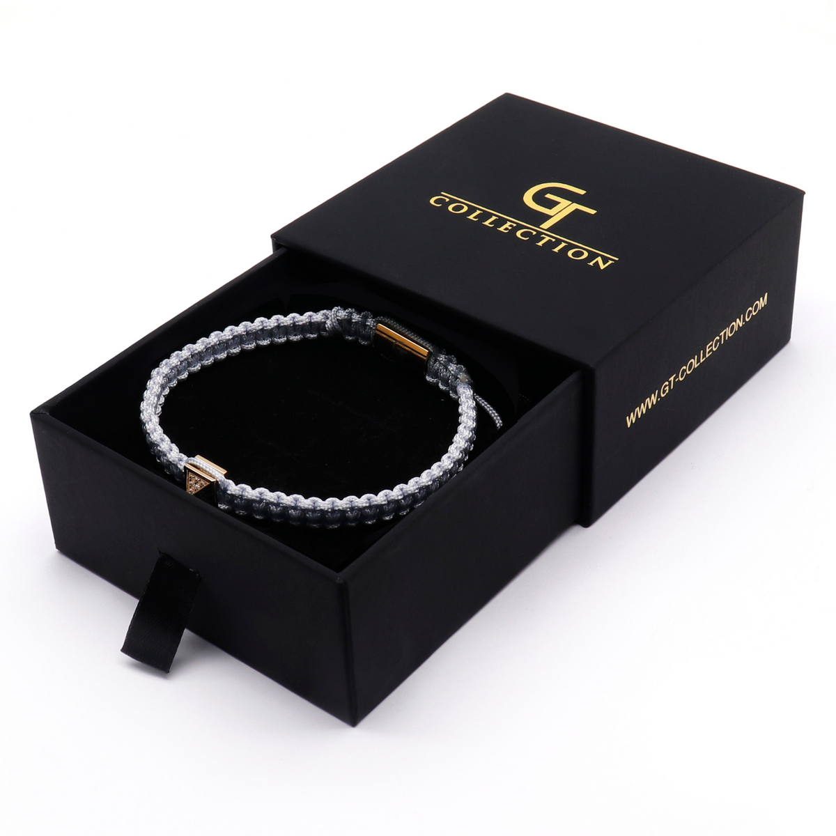 Men's pyramid bracelet shown in black gift box with light gray cord and gold pyramid clasp
