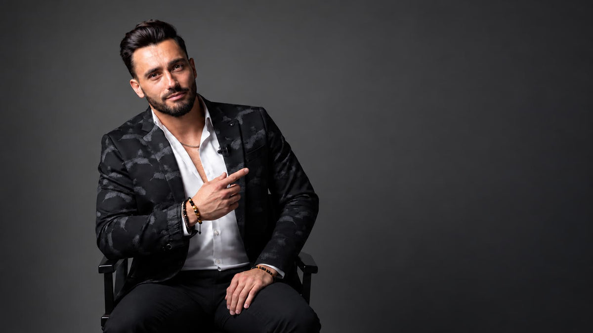 Confident man in studio portrait wearing a men’s gemstone bead bracelet