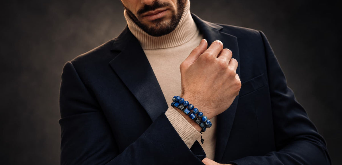 Close-up of a man wearing a blue Lapis Lazuli bracelet with gold details